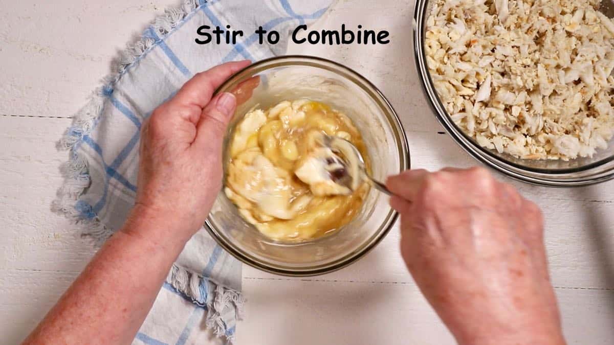 Mixing mayonnaise, dijon mustard and egg in a small bowl.