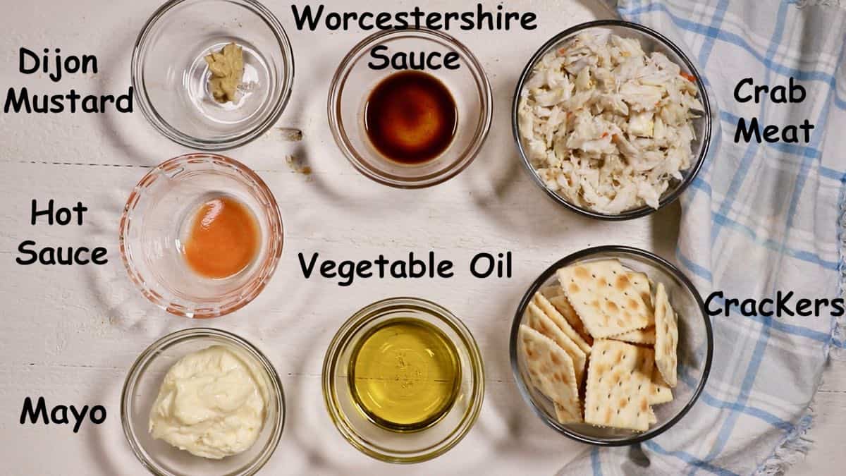 Crab cake ingredients including crab meat, crackers, seasonings, egg and mayonnaise.