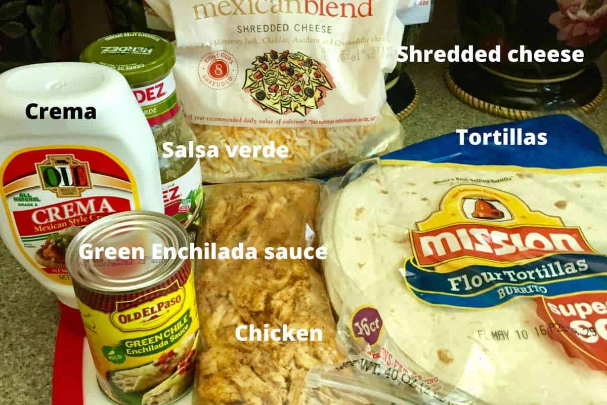 Enchilada ingredients including tortillas, enchilada sauce, salsa verde, and chicken. 