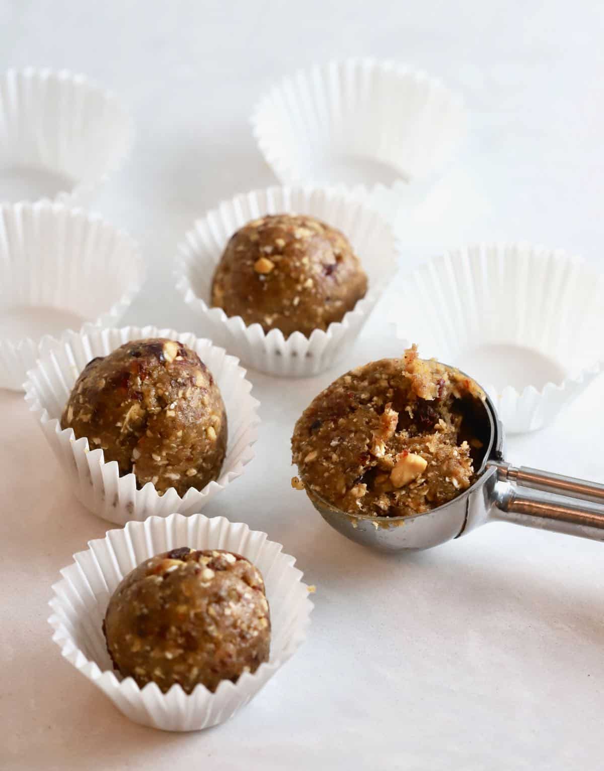 White mini cupcake liners with a oatmeal energy ball in them. 