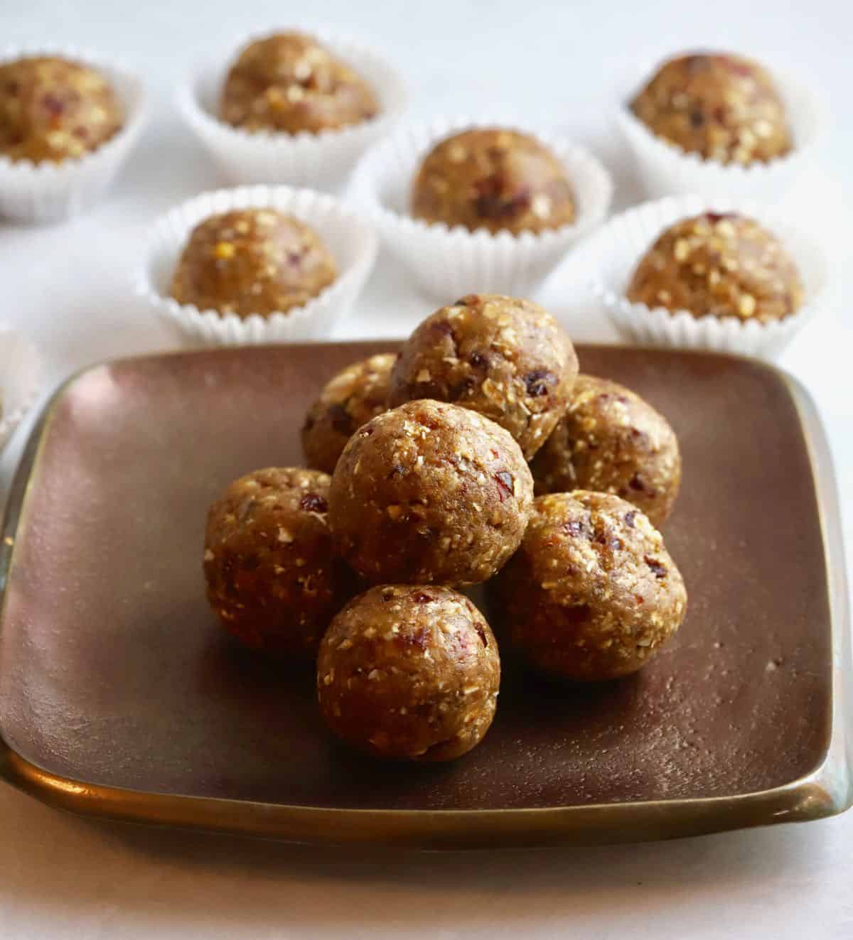 A bronze plate full of oatmeal energy balls. 