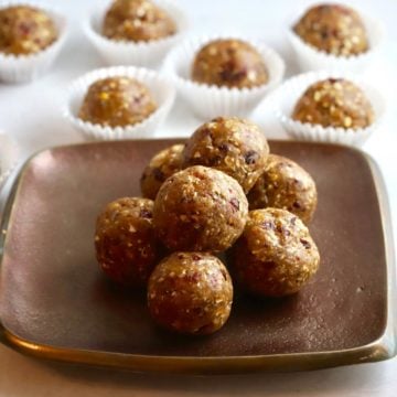 Seven energy balls stacked on a bronze plate.