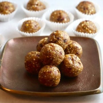 Seven energy balls stacked on a bronze plate.