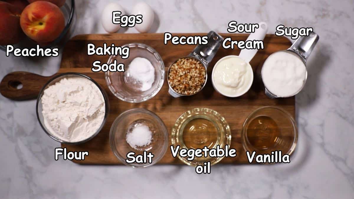 Ingredients to make peach bread including peaches, flour and sugar.