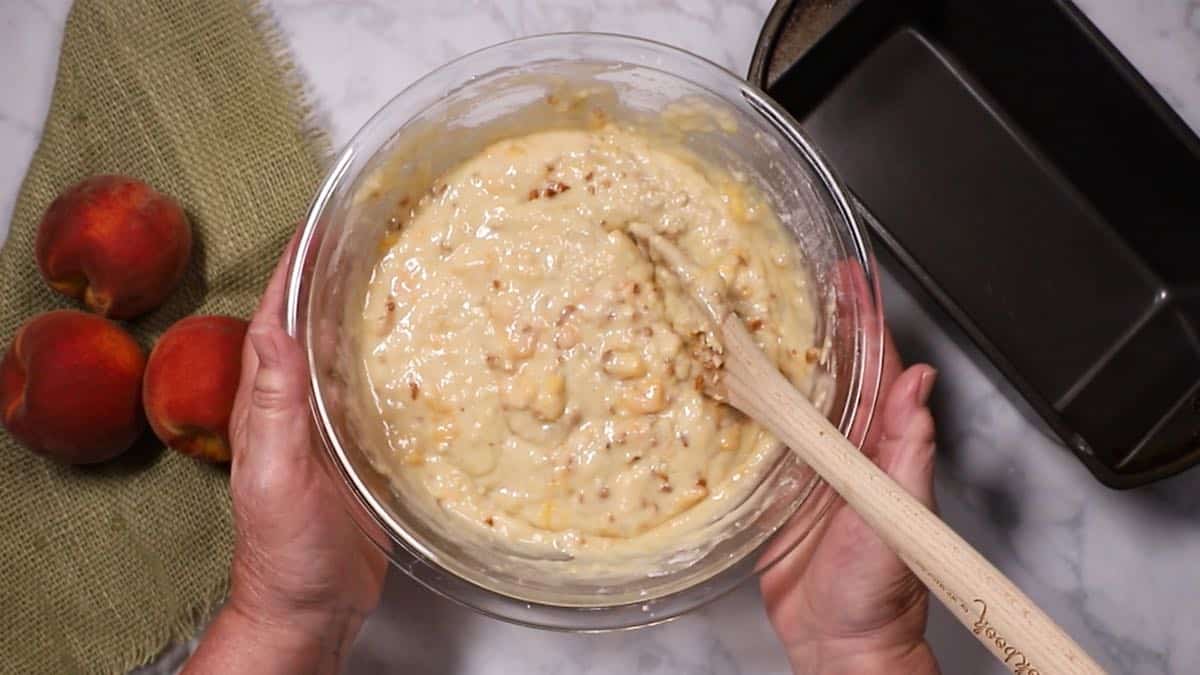 Batter in a clear glass bowl to make quick bread. 