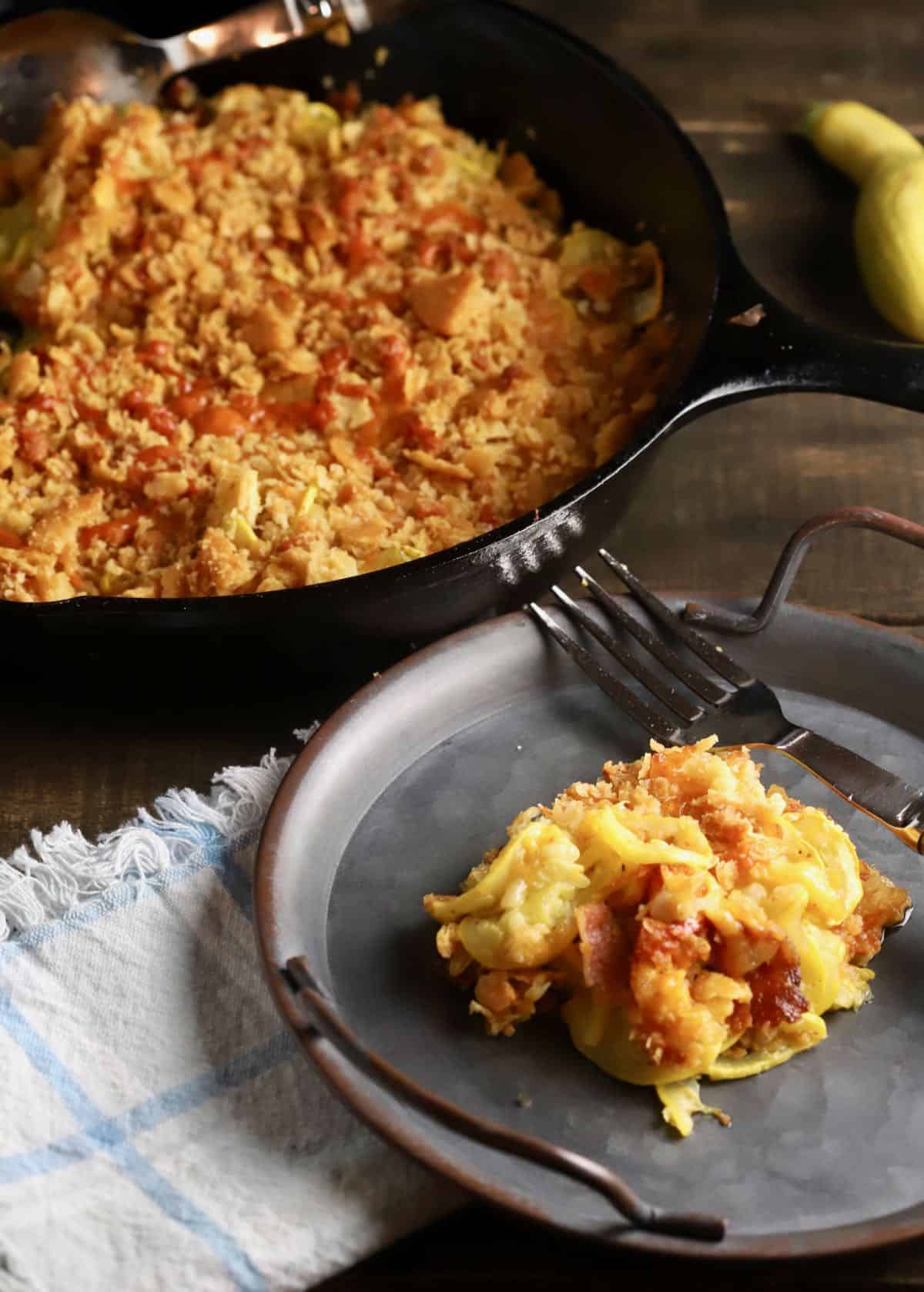 A cast-iron skillet full of squash casserole. 