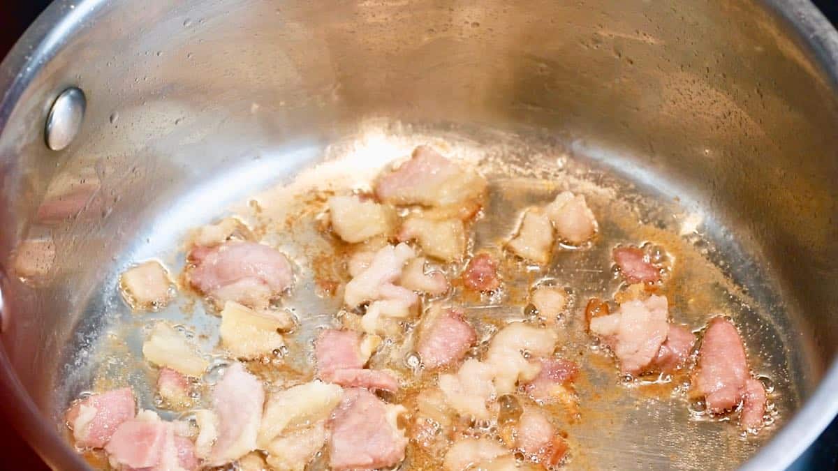 Salt pork cooking in a saucepan. 