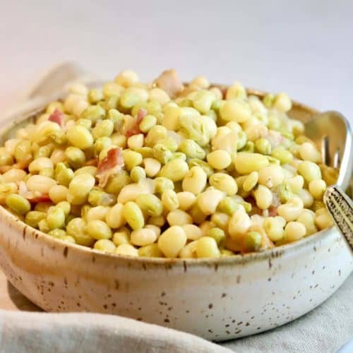 A pottery bowl full of zipper peas.
