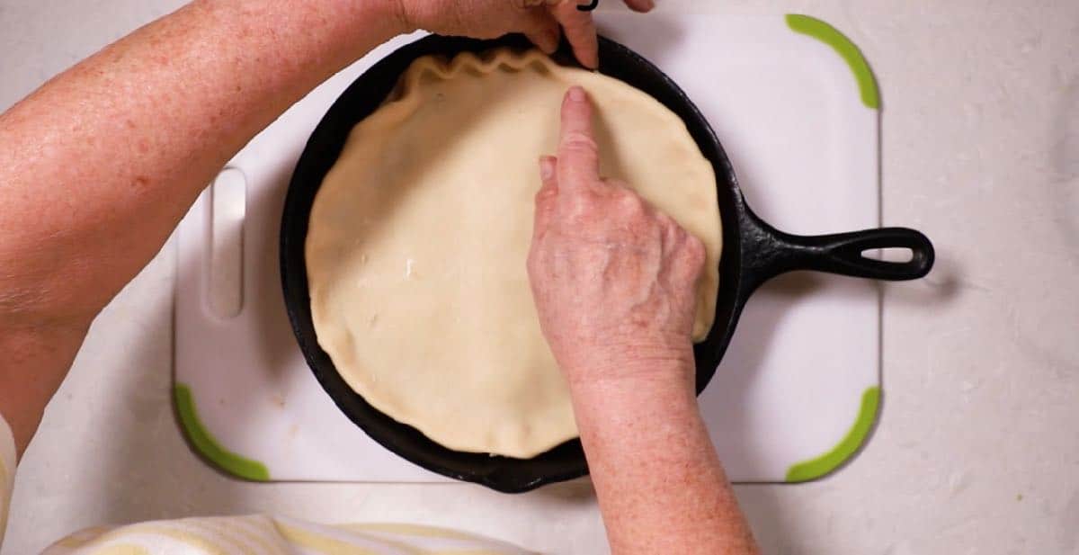 Fluting the edges of a pie crust. 