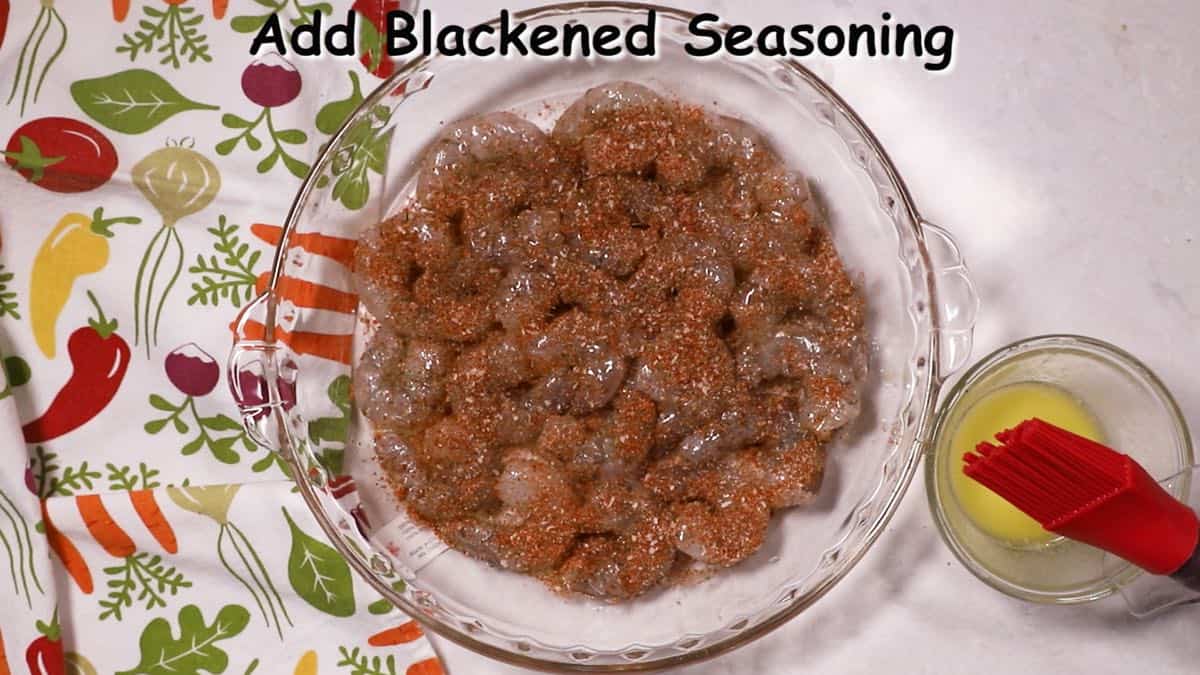 Blackened seasoning mix over raw shrimp.