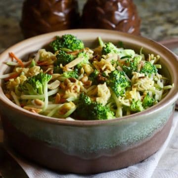 Broccoli slaw with ramen noodles salad in a pottery bowl.