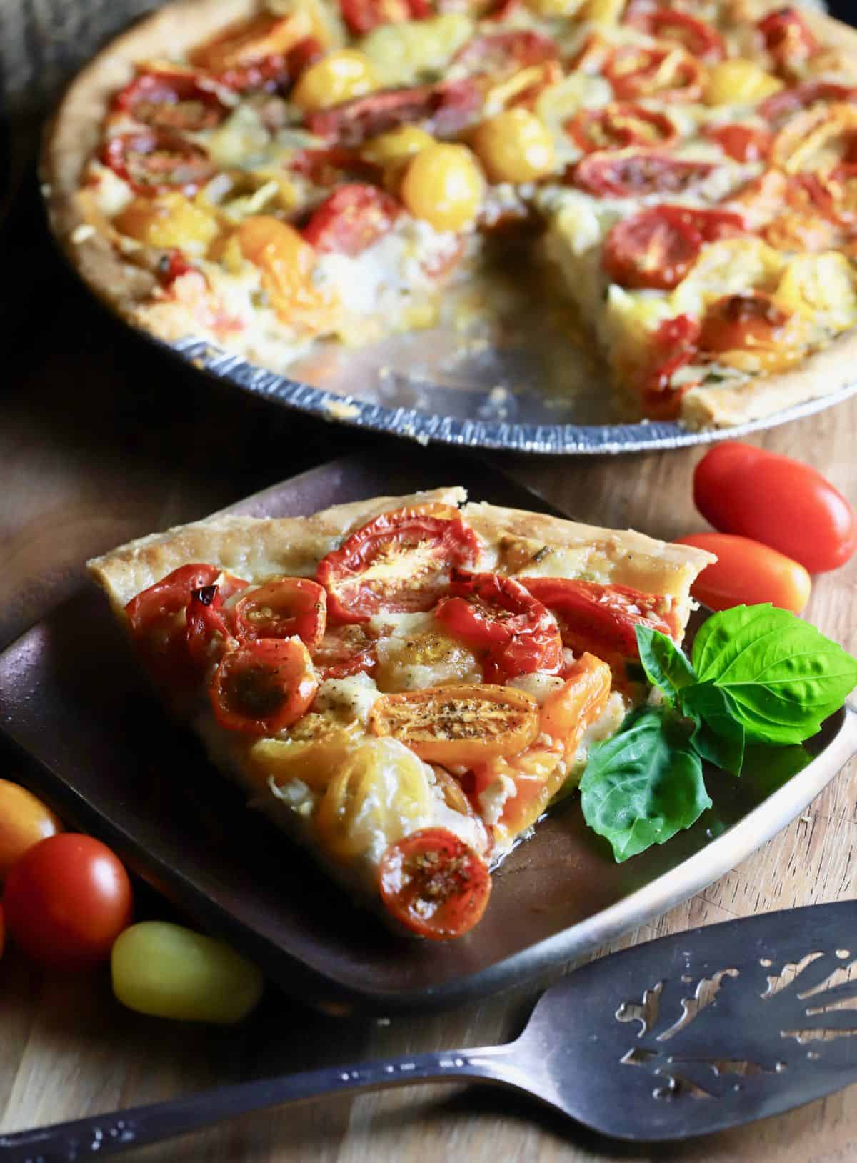 A slice of tomato pie on a plate. 