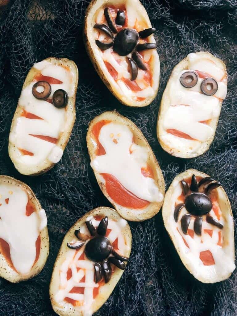 Halloween pizza potato skins with sliced olives for eyes. 