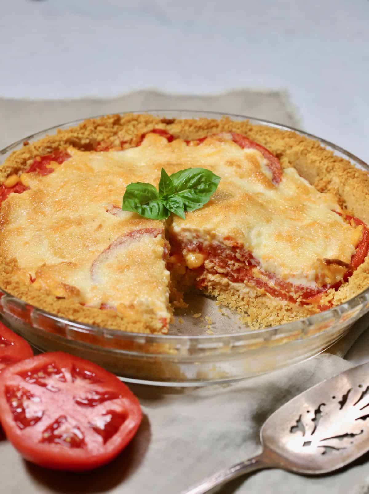 A tomato pie with a slice cut out.