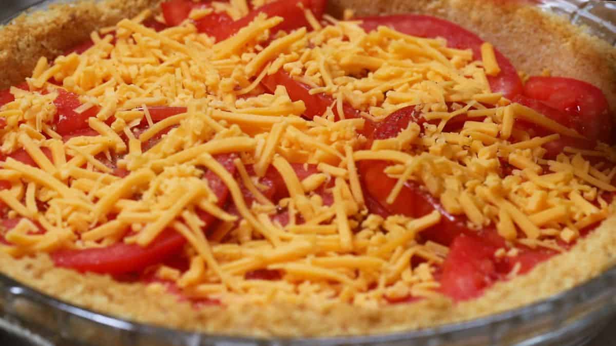 Sliced tomatoes topped with shredded cheese. 