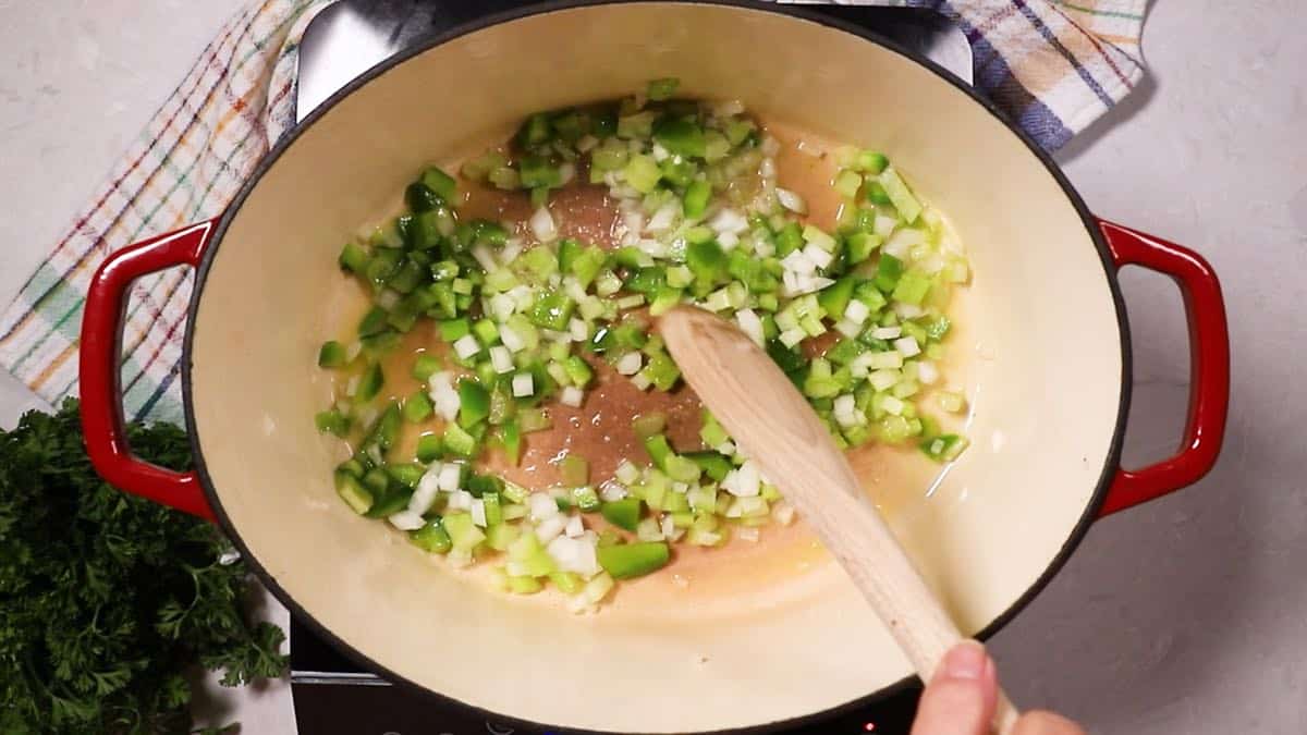 Cooking onions, bell pepper and celery in a Dutch oven. 