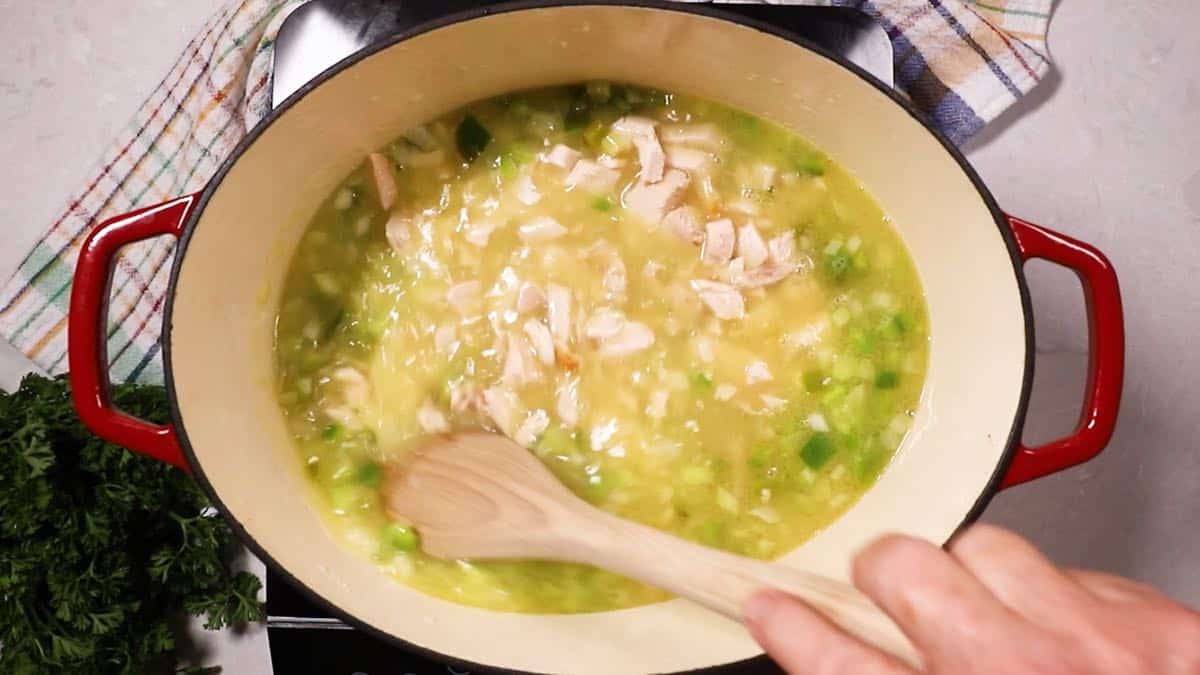 Cooking chicken and rice in a Dutch oven. 