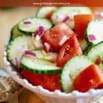 Pinterest pin showing a cucumber and tomato salad in a bowl.