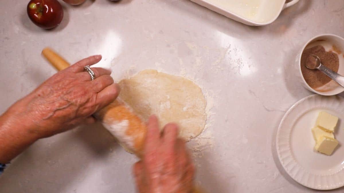 Using a rolling pin to roll out pie dough. 