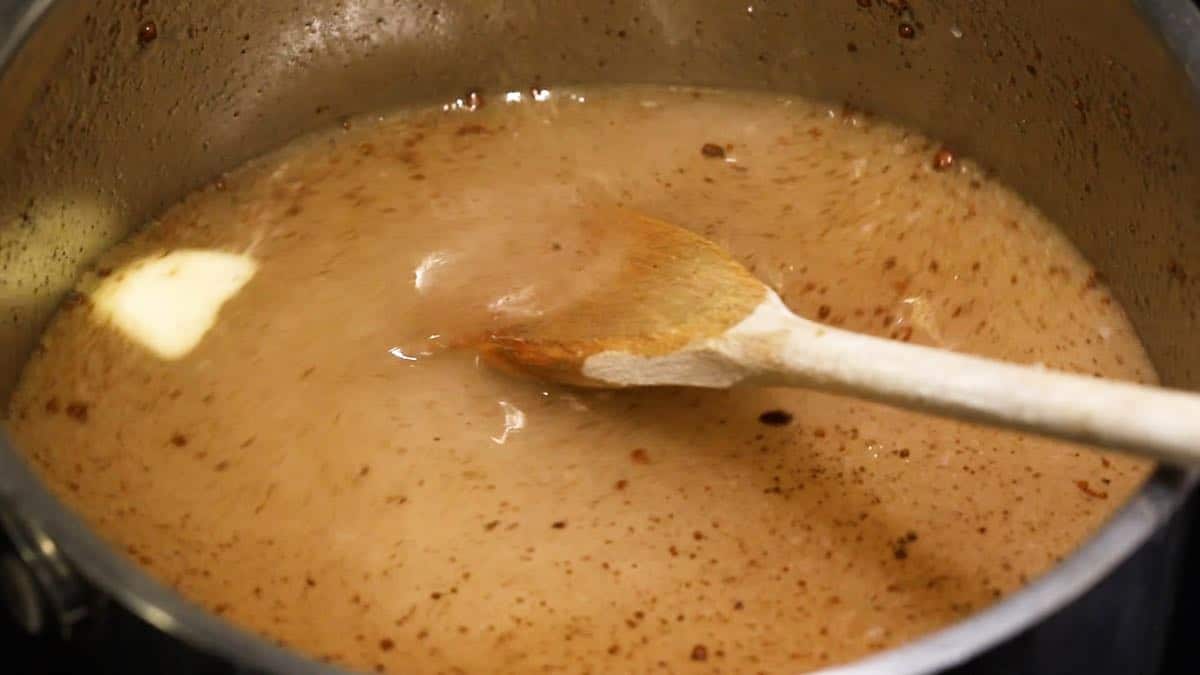 Sauce for apple dumplings in a saucepan. 