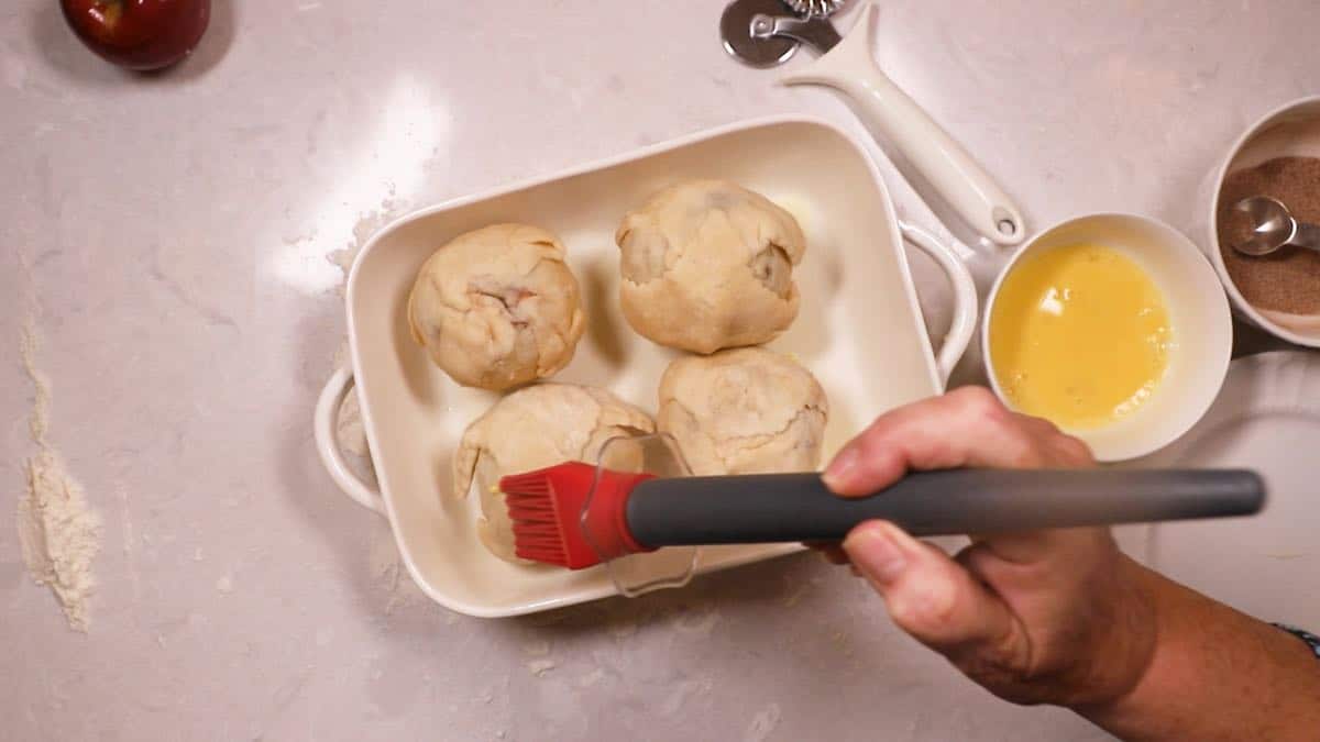 Brushing egg wash on pastry dough. 