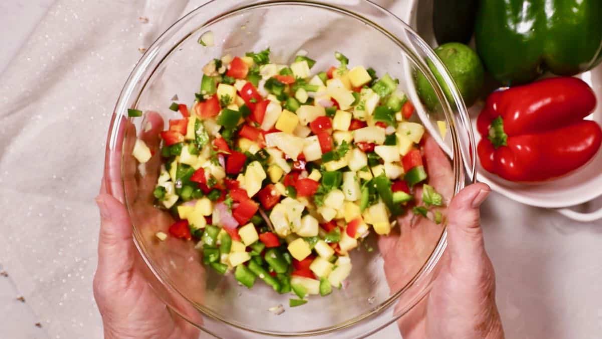 Mango salsa in a clear glass bowl. 