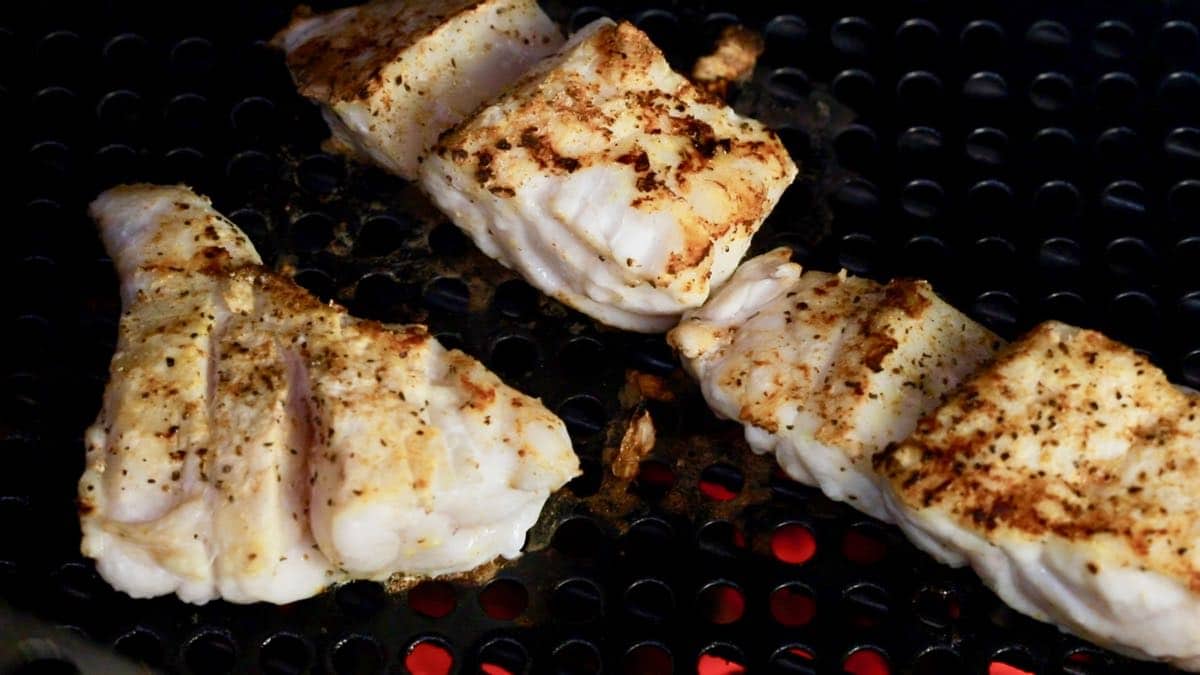 Cooking fish fillets on a grill. 