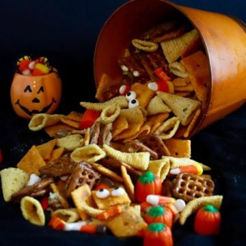 Monster Munch a Halloween Snack Mix falling out of an orange pail.