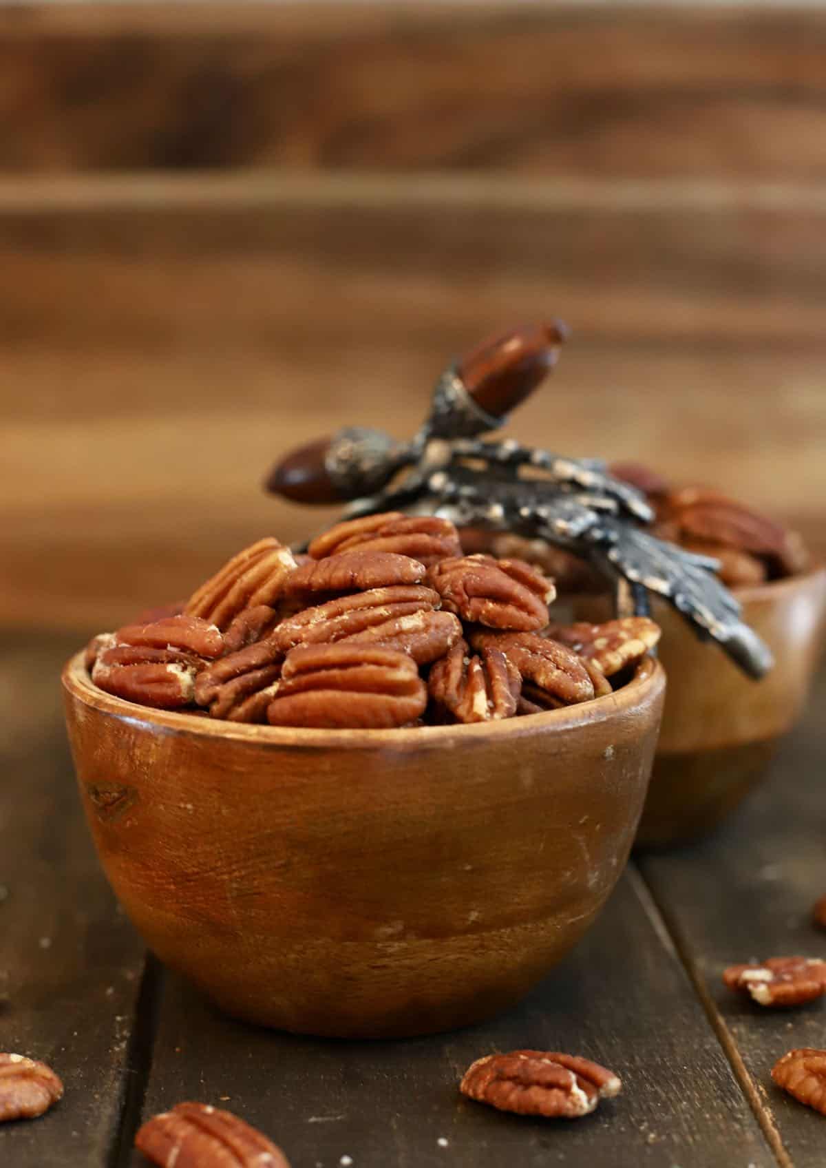 Roasted pecans in a wooden dish. 