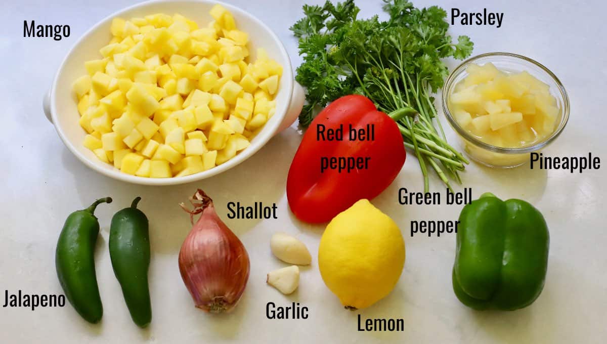 Mango salsa ingredients including mango, bell peppers and pineapple. 