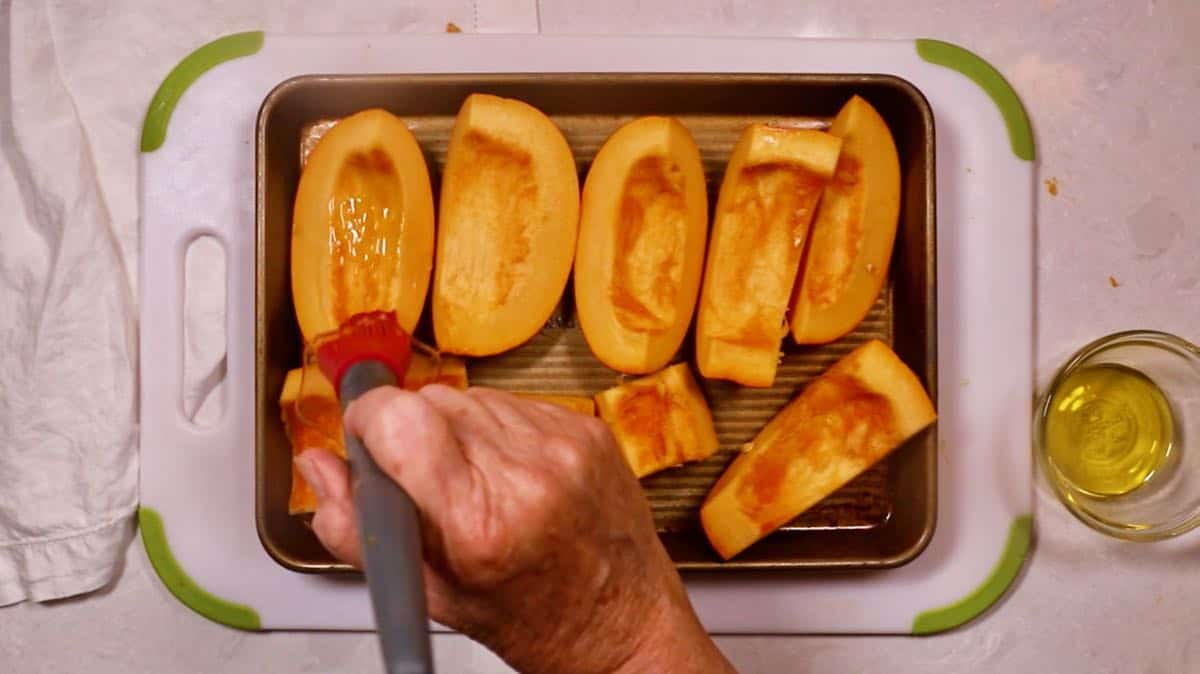 Pumpkin pieces on a baking sheet. 