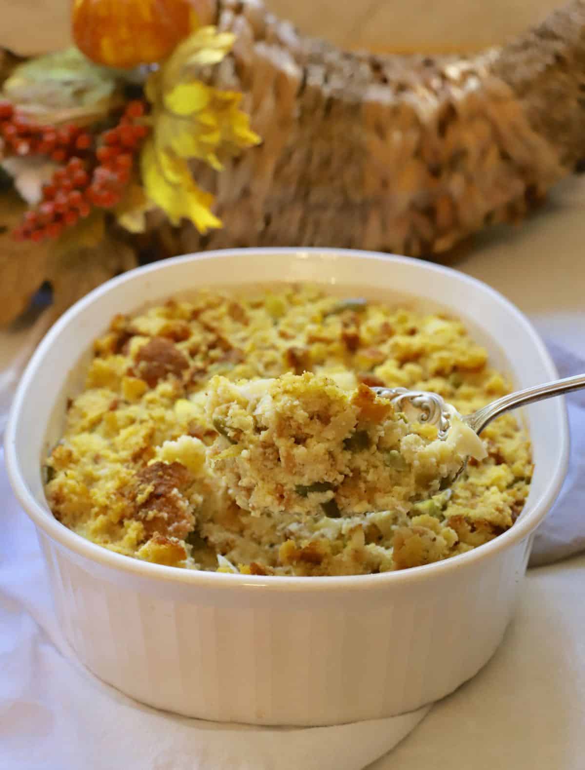 A large white bowl of cornbread dressing.