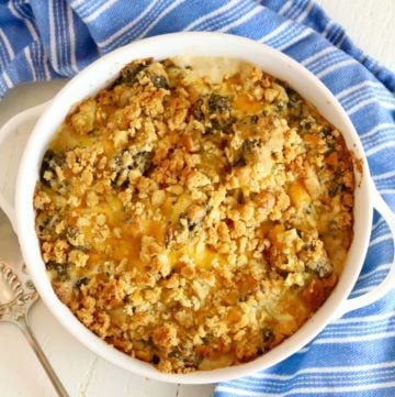 Broccoli cheese casserole on a blue kitchen towel.