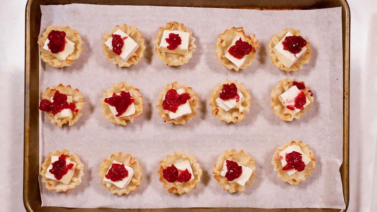 Cranberry brie bites on a baking sheet. 