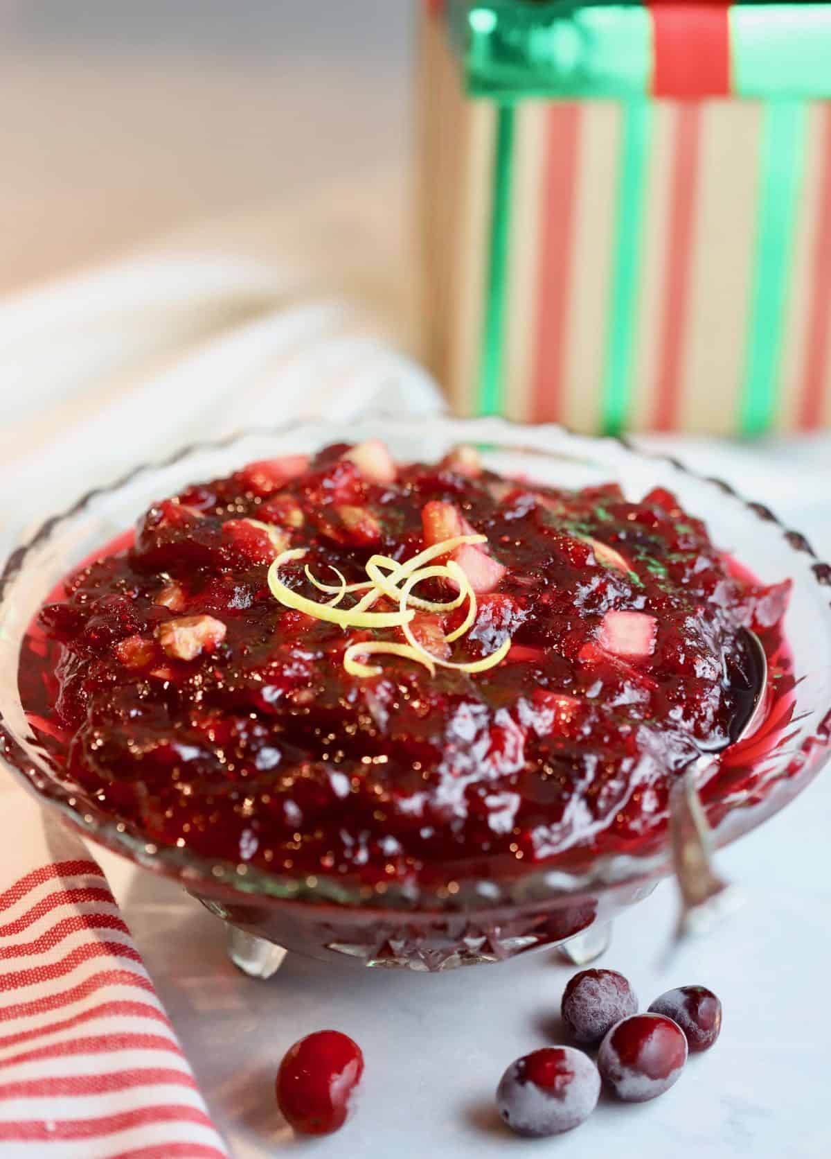 Cranberry sauce in a clear glass bowl.