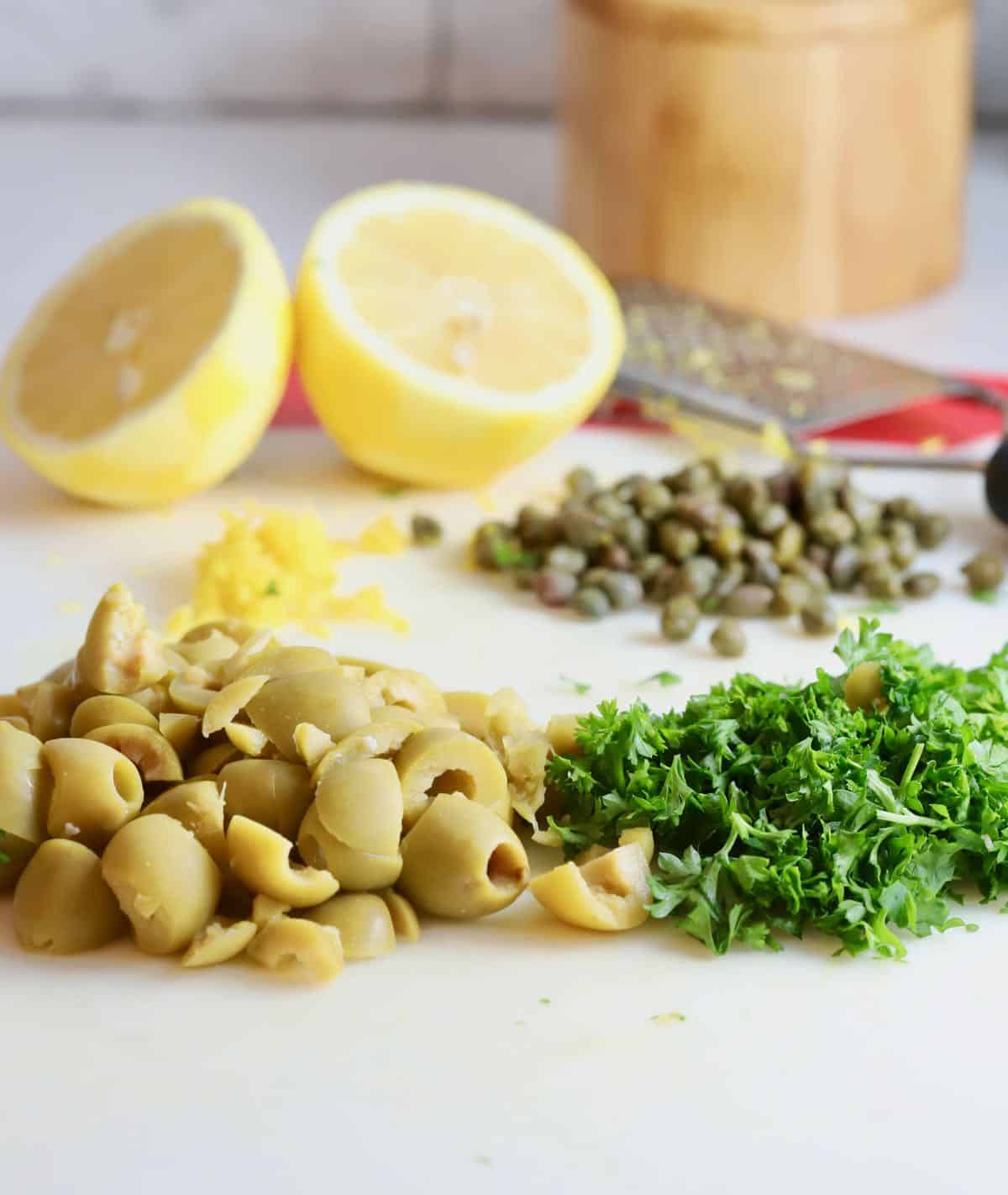 Chopped green olives, capers and slices of lemon.