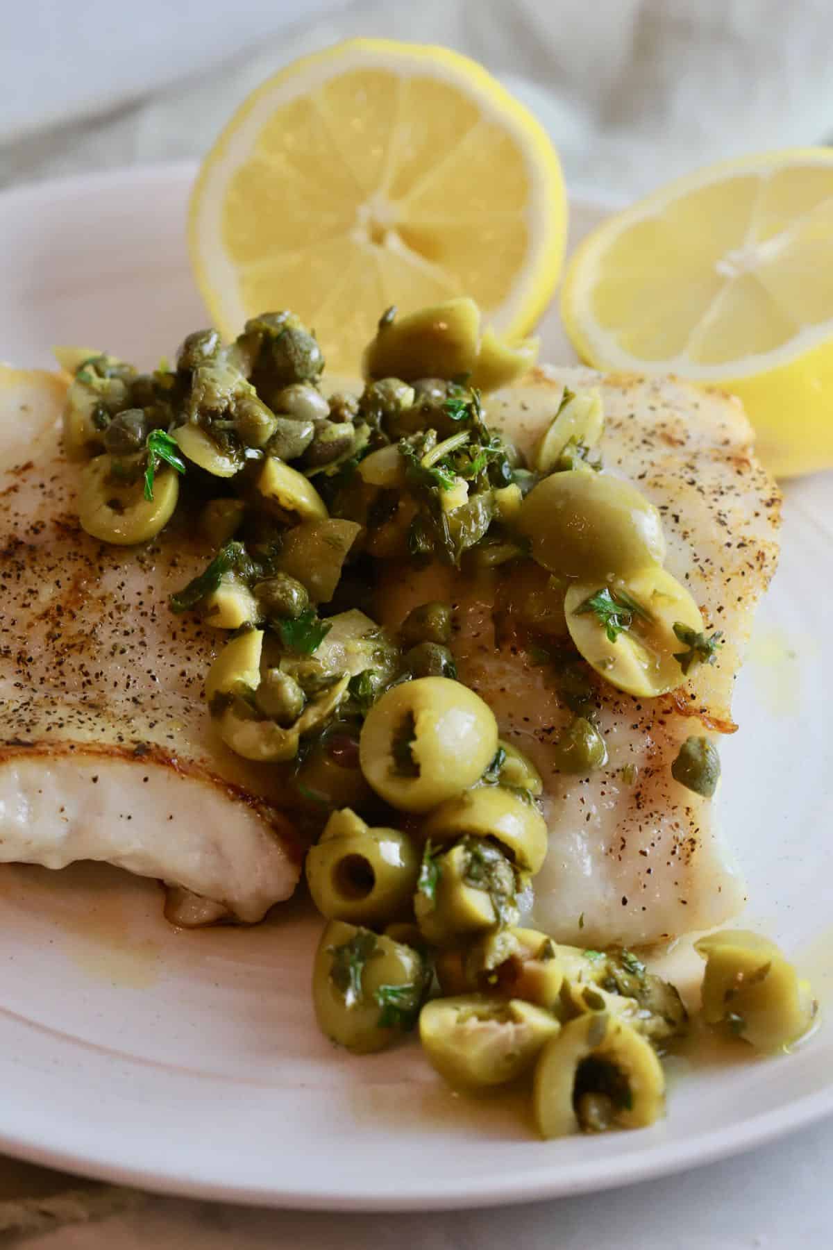 Grouper fillets topped with a Mediterranean topping of olives and capers. 