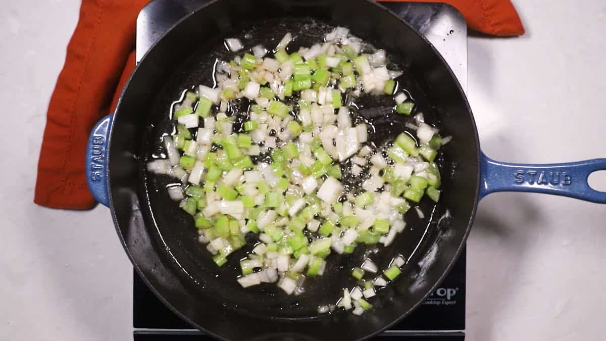 Celery and onion cooking in a skillet.