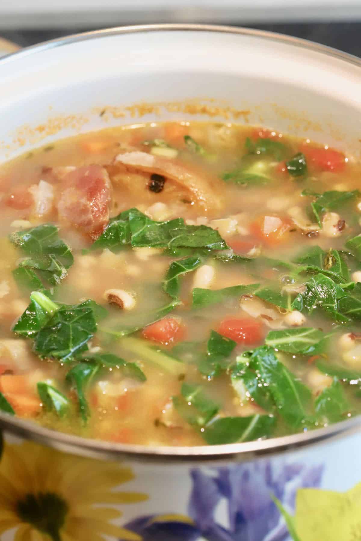 Collard greens cooking in black-eyed pea soup. 