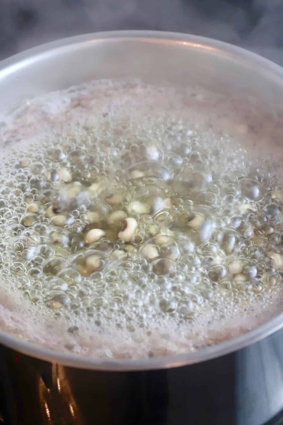 Black-eyed peas boiling in a pot.