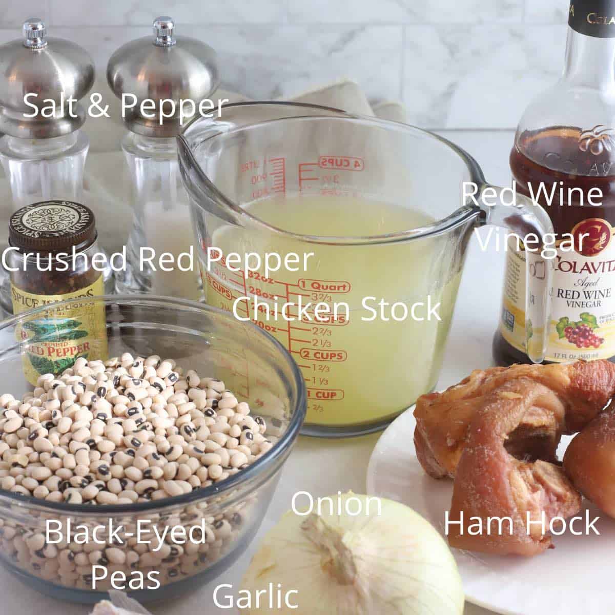 Ingredients to make black-eyed peas including dried peas, chicken stock and a ham hock. 