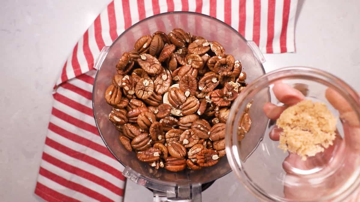 Pecans in the bowl of a food processor.