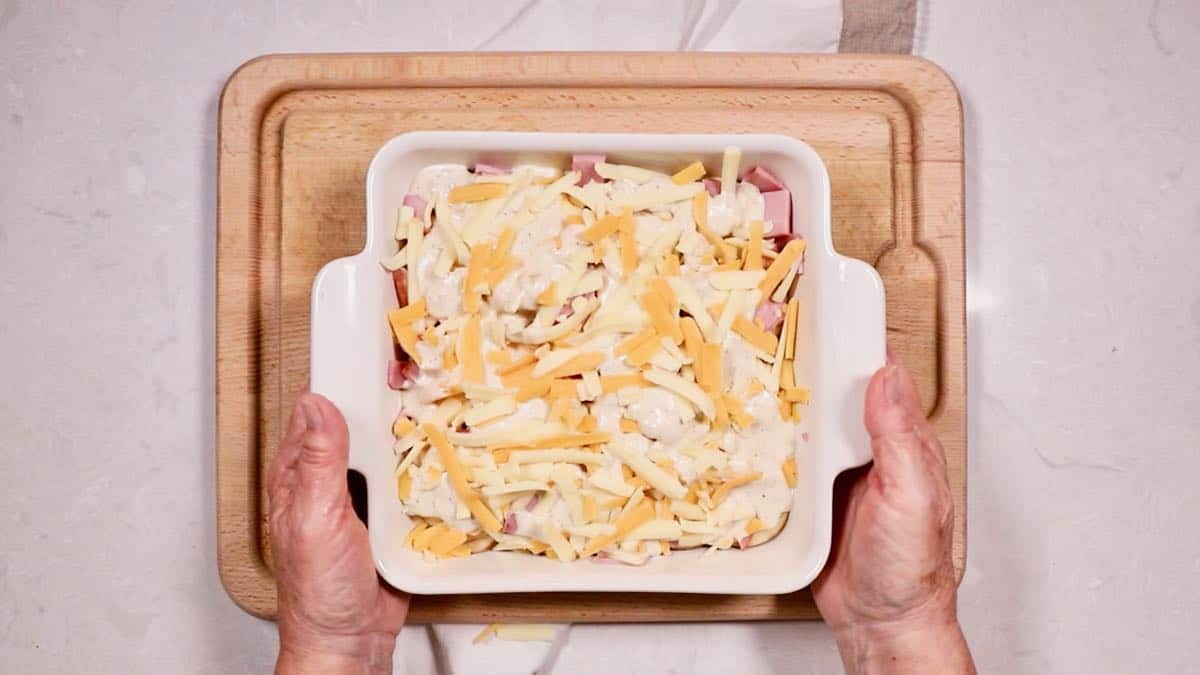 Potato and Ham Au Gratin in a baking dish ready for the oven. 