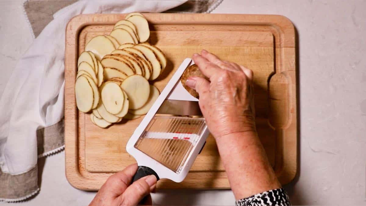 Slicing potatoes with a mandolin. 