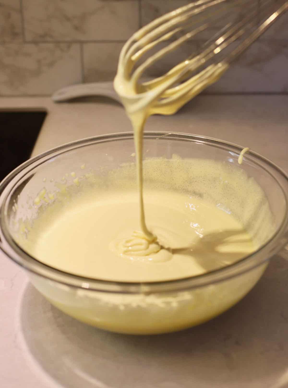 Whisking egg yolks and sugar together. 