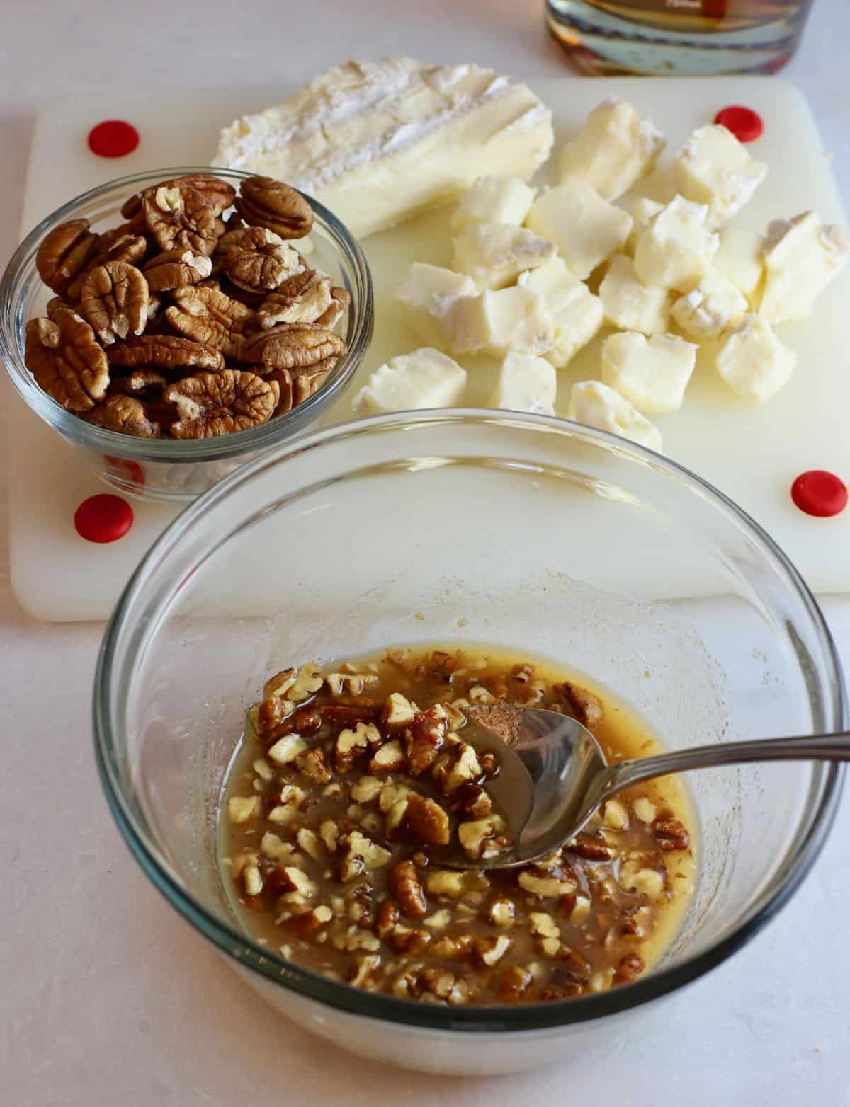 Bourbon, butter, pecans and brown sugar in a bowl. 