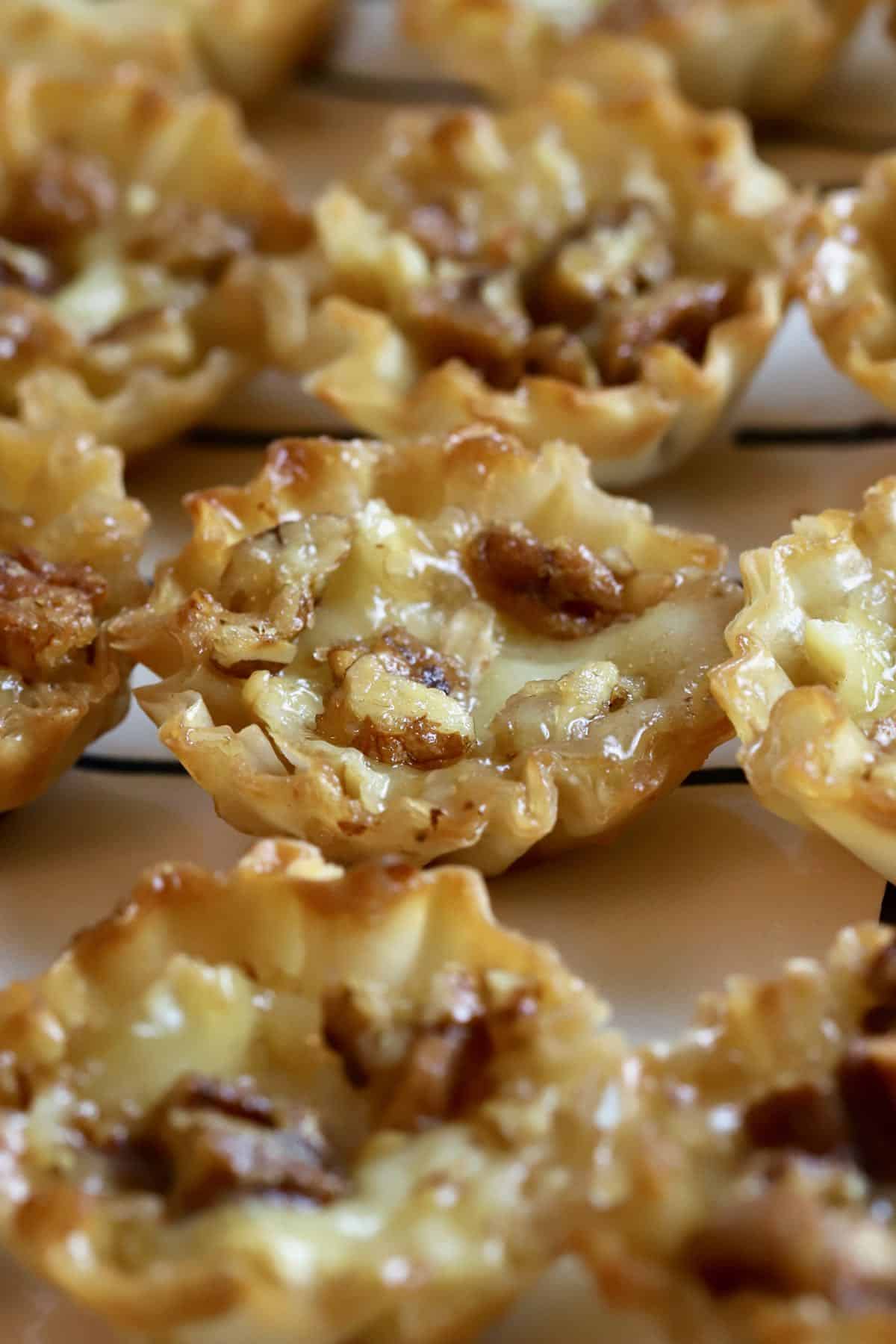 Bourbon pecan brie bites on a serving dish.