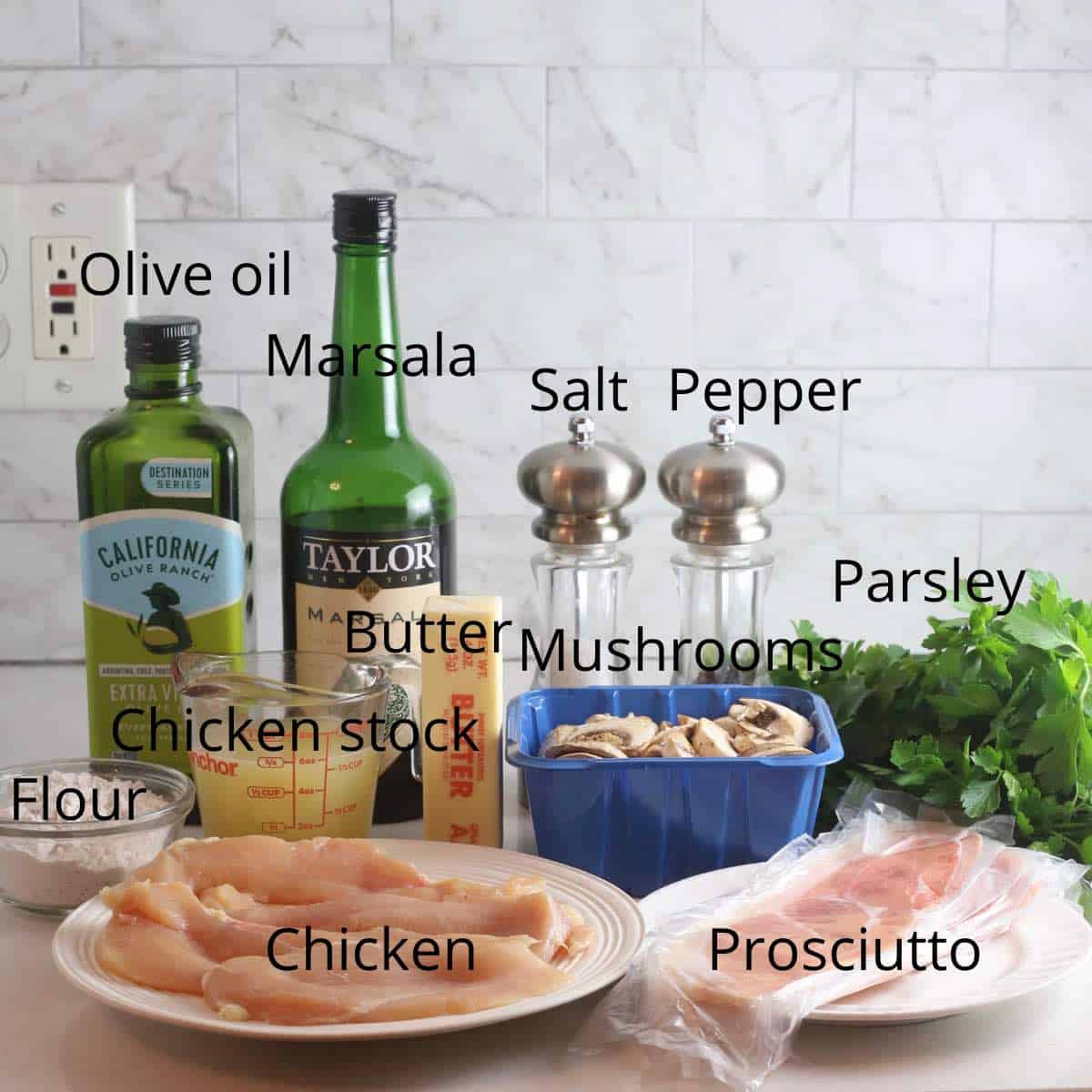 Ingredients for Chicken Marsala including Marsala wine, parsley and olive oil. 