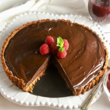 Chocolate Ganache Tart with a slice cut out.