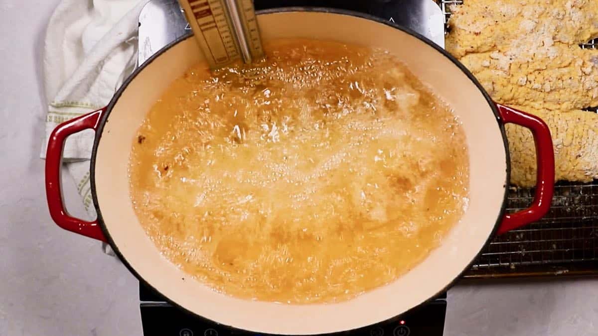 Fish fillets being deep-fried in a Dutch oven. 